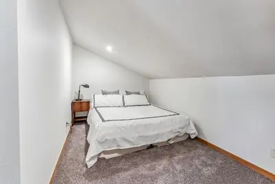 a bedroom with a bed in a white room at Keystone Retreat with Resort Amenities in Keystone