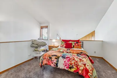 a bedroom with a large bed and a chair at Keystone Retreat with Resort Amenities in Keystone