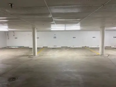 an empty parking lot with white columns in a parking garage at Keystone Retreat with Resort Amenities in Keystone
