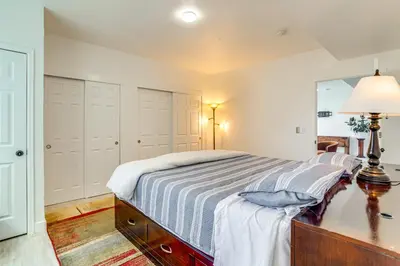 a bedroom with a bed and a mirror at Family-Friendly Aurora Apt with Shared Patio! in Aurora