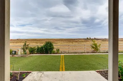 a view of a field from a window at Family-Friendly Aurora Apt with Shared Patio! in Aurora