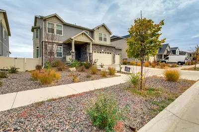 a house in a neighborhood with a driveway at Family-Friendly Aurora Apt with Shared Patio! in Aurora