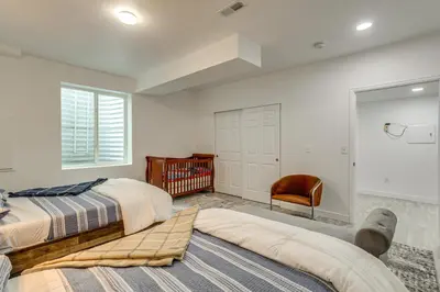 a bedroom with two beds and a chair at Family-Friendly Aurora Apt with Shared Patio! in Aurora