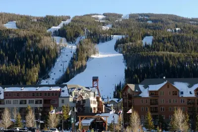 a resort with a snow covered slope and trees at Ski Run 307 - Mountain House Keystone in Keystone