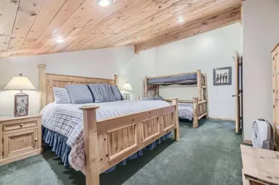 a bedroom with a large wooden bed in a room at Ski Run 307 - Mountain House Keystone in Keystone