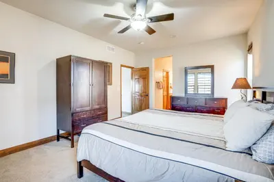 a bedroom with a large bed and a ceiling fan at Mtn Views and Private Hot Tub Granby Group Getaway! in Granby