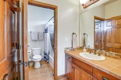 a bathroom with a sink and a toilet at Mtn Views and Private Hot Tub Granby Group Getaway! in Granby