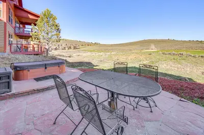a table and chairs on a patio with a grill at Mtn Views and Private Hot Tub Granby Group Getaway! in Granby