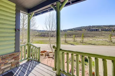 a front porch with a view of a field at Mtn Views and Private Hot Tub Granby Group Getaway! in Granby