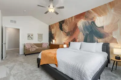 a bedroom with a bed and a painting on the wall at NOCO Retreat with King Beds, Fireplace, Scenic Trails in Loveland