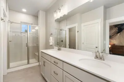 a white bathroom with two sinks and a shower at NOCO Retreat with King Beds, Fireplace, Scenic Trails in Loveland