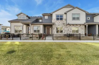a house with a fence in front of a yard at NOCO Retreat with King Beds, Fireplace, Scenic Trails in Loveland
