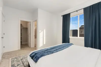 a white bedroom with a bed and a window at NOCO Retreat with King Beds, Fireplace, Scenic Trails in Loveland