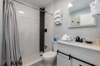 a bathroom with a toilet and a sink and a shower at Meadow Cove B1 condo in Dillon