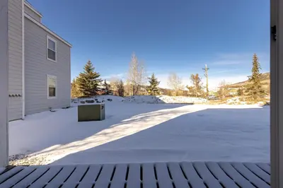 a driveway covered in snow next to a building at Meadow Cove B1 condo in Dillon