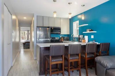 a kitchen with blue walls and a bar with chairs at Meadow Cove B1 condo in Dillon