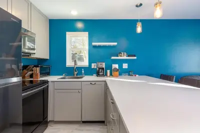 a kitchen with blue walls and a white counter top at Meadow Cove B1 condo in Dillon