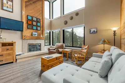 a living room with a couch and a tv at The Mall 1429 condo in Keystone
