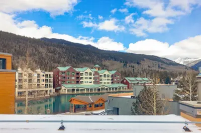 a view of a resort with mountains in the background at The Mall 1429 condo in Keystone
