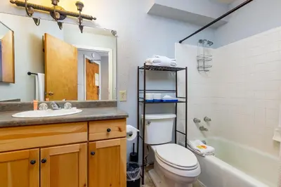 a bathroom with a toilet and a sink and a tub at The Mall 1429 condo in Keystone