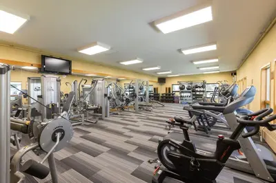 a gym with cardio equipment and tread machines at The Mall 1429 condo in Keystone