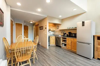a kitchen with a table and a refrigerator at The Mall 1429 condo in Keystone