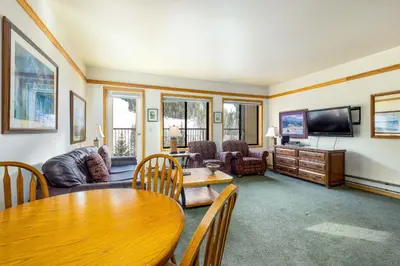a living room with a table and a tv at 2797 Slopeside condo in Keystone