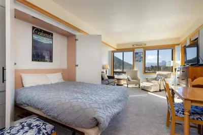 a bedroom with a bed and a desk in a room at 2756 Slopeside condo in Keystone