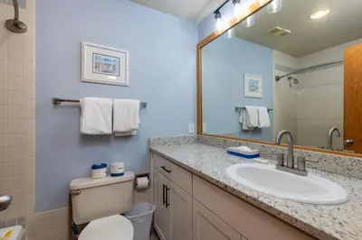 a bathroom with a sink and a toilet and a mirror at 2756 Slopeside condo in Keystone