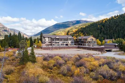 an aerial view of a large building with mountains in the background at 2756 Slopeside condo in Keystone