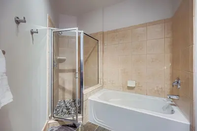 a bathroom with a shower and a white bath tub at 2301 Red Hawk Lodge condo in Snake River Health Services Incorporated Heliport