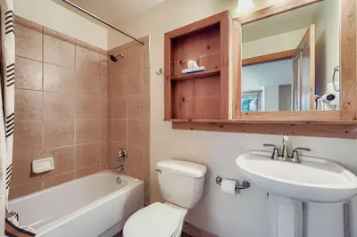 a bathroom with a sink and a toilet and a tub at 2301 Red Hawk Lodge condo in Snake River Health Services Incorporated Heliport