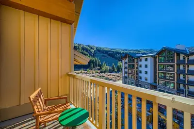 a balcony with a chair and a view of a city at 2301 Red Hawk Lodge condo in Snake River Health Services Incorporated Heliport