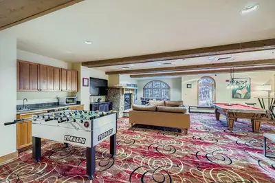 a kitchen and living room with a ping pong table at 2301 Red Hawk Lodge condo in Snake River Health Services Incorporated Heliport