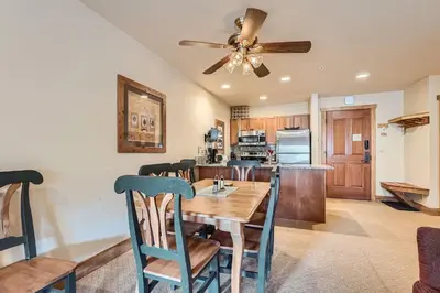 a dining room and kitchen with a table and chairs at 2263 Red Hawk Lodge condo in Keystone