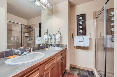 a bathroom with two sinks and a shower at 2263 Red Hawk Lodge condo in Keystone