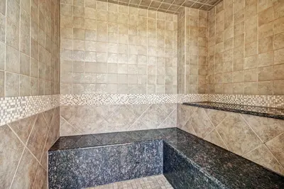 a bathroom with a large shower with tiled walls at 2263 Red Hawk Lodge condo in Keystone