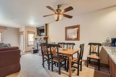 a dining room with a table and chairs at 2263 Red Hawk Lodge condo in Keystone