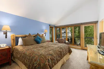 a bedroom with a bed and a large window at 2708 Chateaux DMont condo in Keystone
