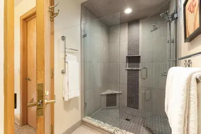 a shower with a glass door in a bathroom at 2708 Chateaux DMont condo in Keystone