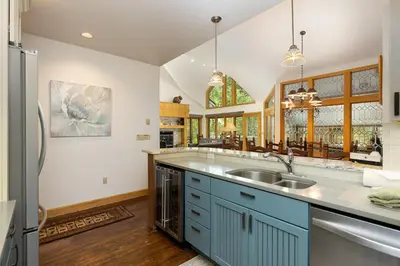 a kitchen with blue cabinets and a sink at 2708 Chateaux DMont condo in Keystone