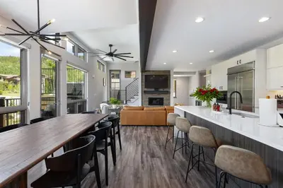 a kitchen and living room with a long table and chairs at Keystone Adventures Basecamp townhouse in Keystone