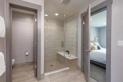 a bathroom with a shower with a tub and a bed at Keystone Adventures Basecamp townhouse in Keystone