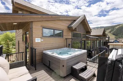 a hot tub on the deck of a house at Keystone Adventures Basecamp townhouse in Keystone