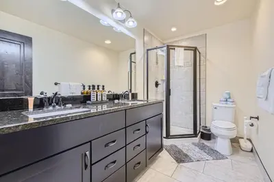 a bathroom with a toilet and a sink and a shower at 58 River Run Townhomes townhouse in Keystone