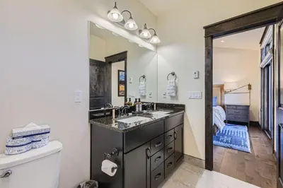 a bathroom with a sink and a large mirror at 58 River Run Townhomes townhouse in Keystone