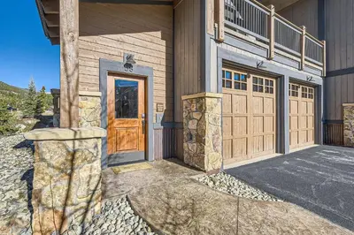 a house with a wooden door and a balcony at 58 River Run Townhomes townhouse in Keystone