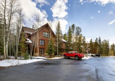 a red truck parked in front of a house at 8766 Trappers Crossing townhouse in Keystone