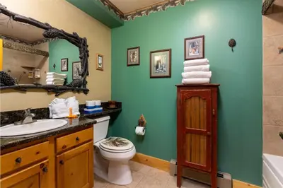 a bathroom with a sink toilet and a mirror at 8766 Trappers Crossing townhouse in Keystone