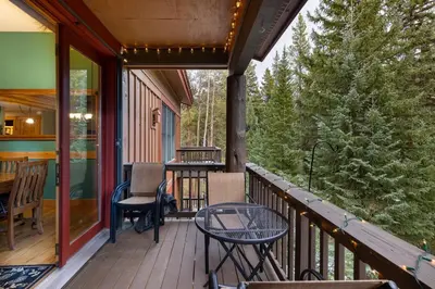 a balcony with a table and chairs on a house at 8766 Trappers Crossing townhouse in Keystone